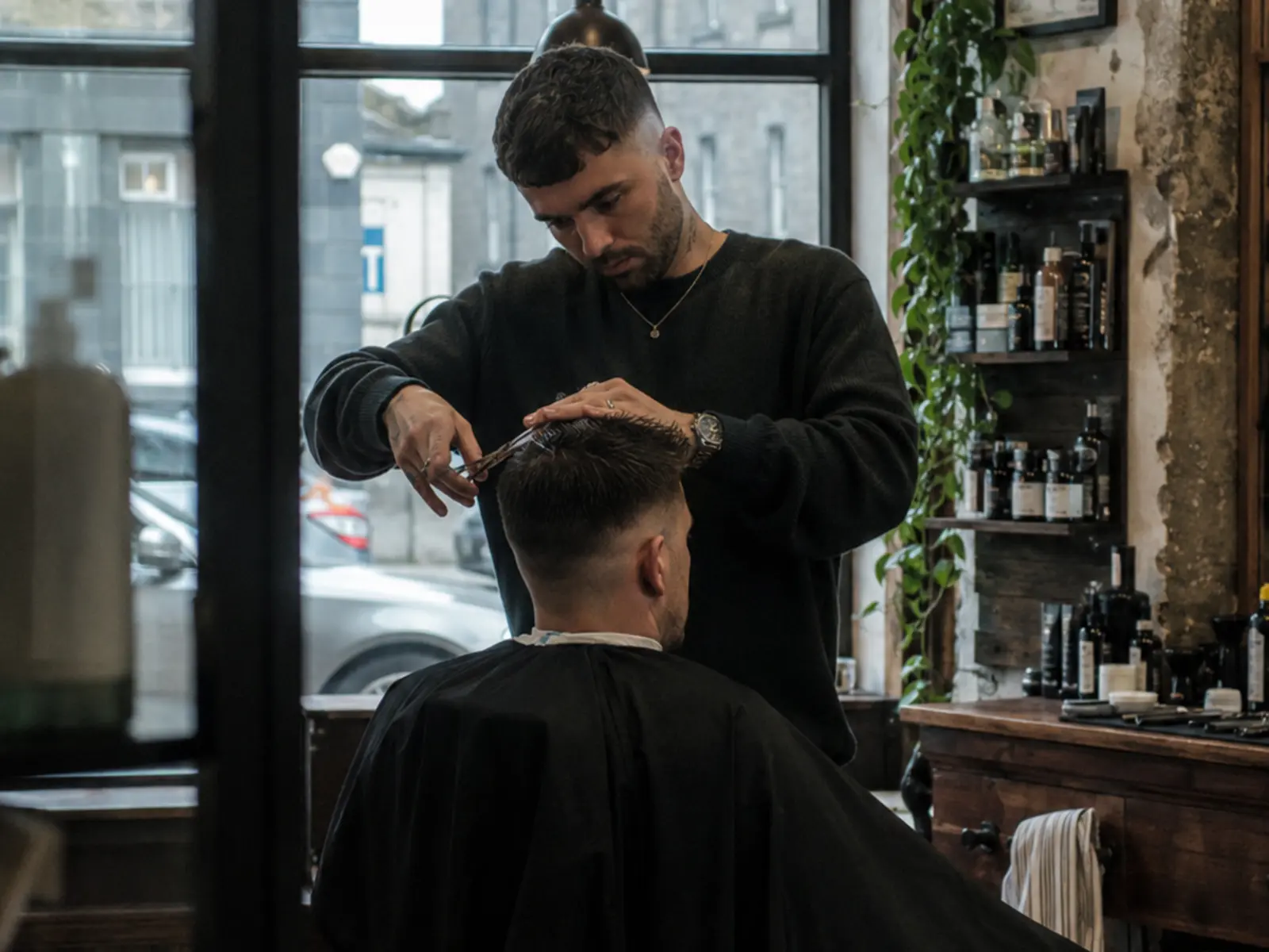 A barber mid-appointment in an Irish salon
