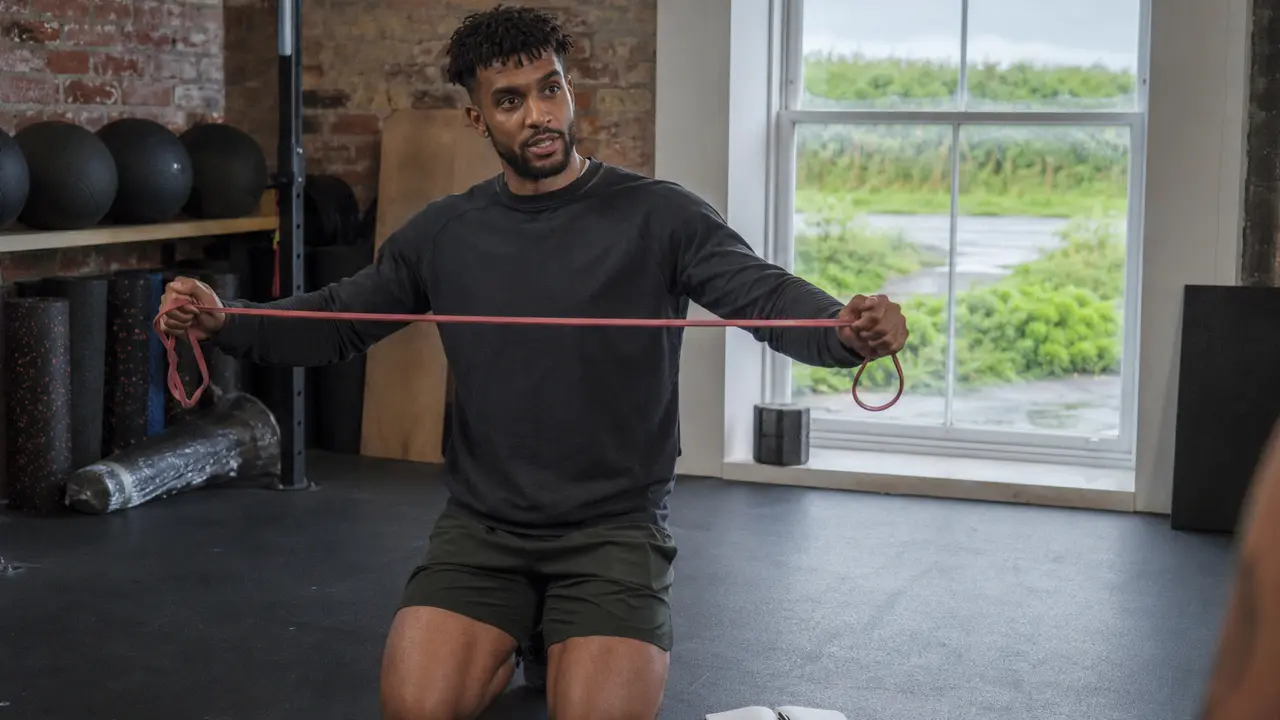 A personal trainer working with a client in a training session